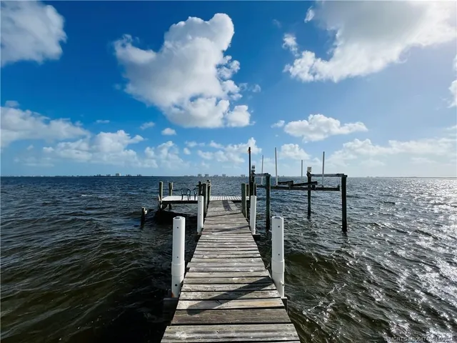a view of a lake with a floor to ceiling window