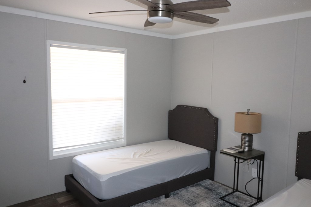 20120 Other Rocksprings, TX 78880 - Photo 16 of 22 a bedroom with a bed and a lamp next to a window