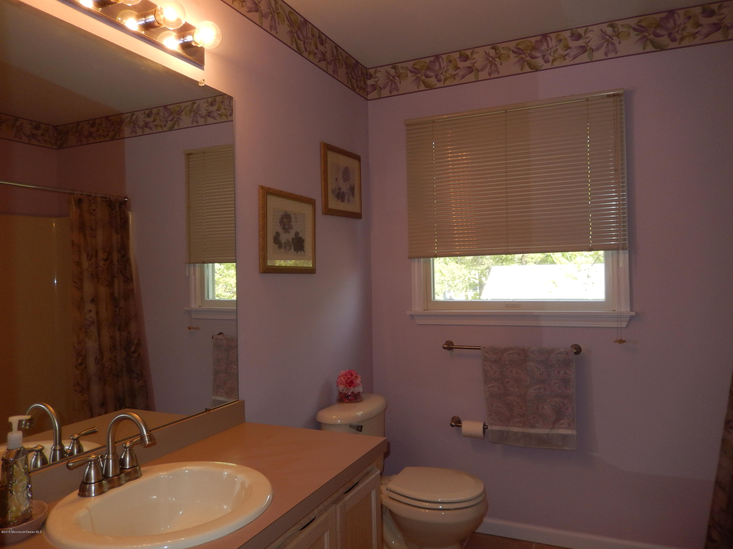 100 Bowsprit Road Manahawkin, NJ 08050 - Photo 11 of 21 a bathroom with a granite countertop sink toilet a mirror and shower