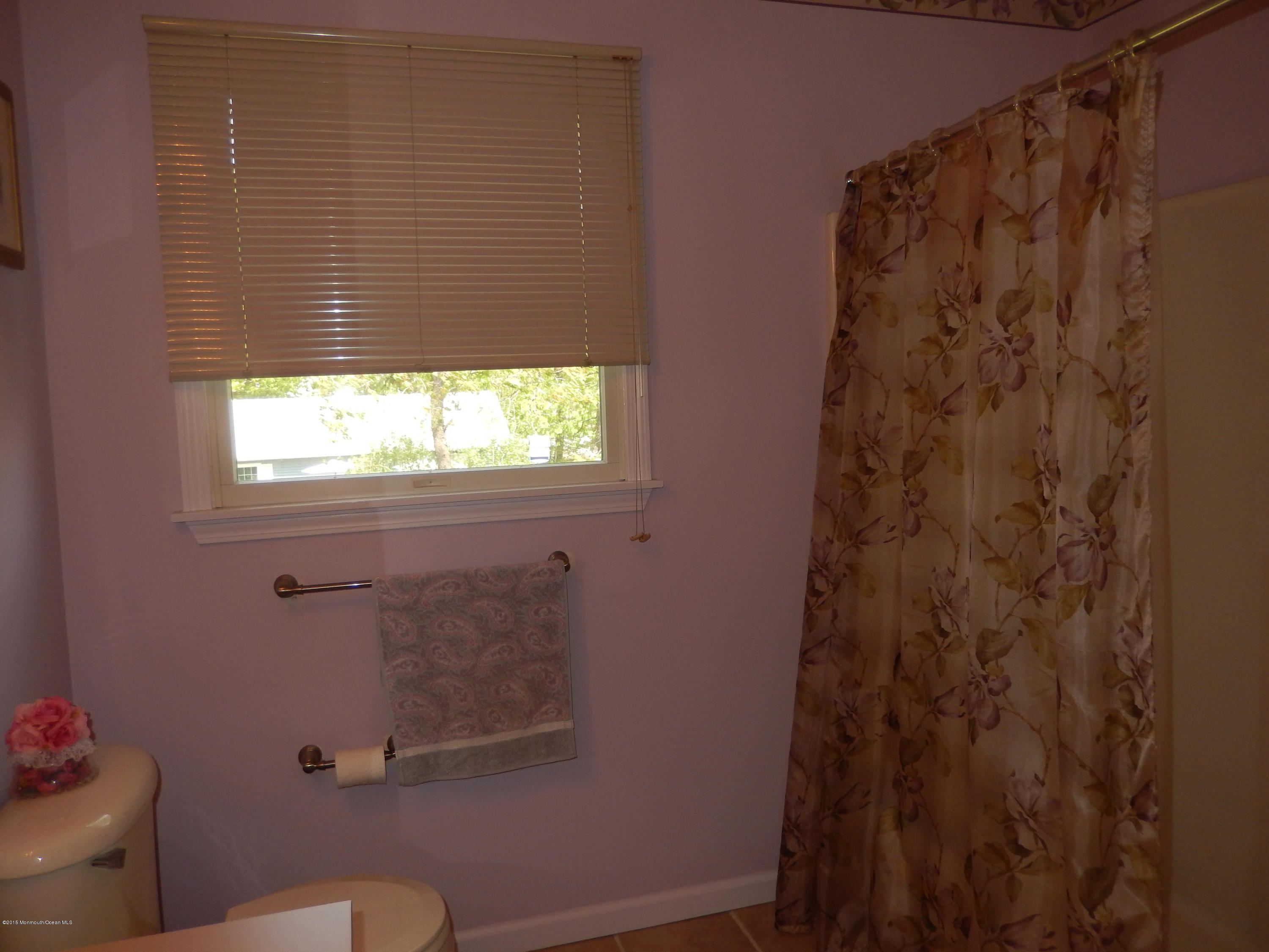 100 Bowsprit Road Manahawkin, NJ 08050 - Photo 12 of 21 a bathroom with a shower curtain and a toilet