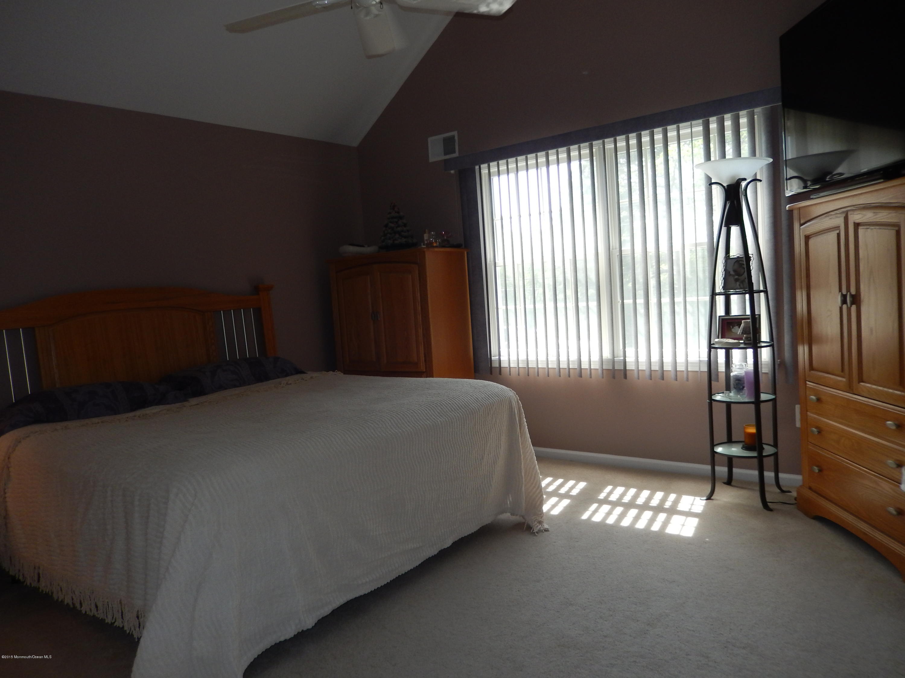 100 Bowsprit Road Manahawkin, NJ 08050 - Photo 14 of 21 a bed sitting in a bedroom next to a window