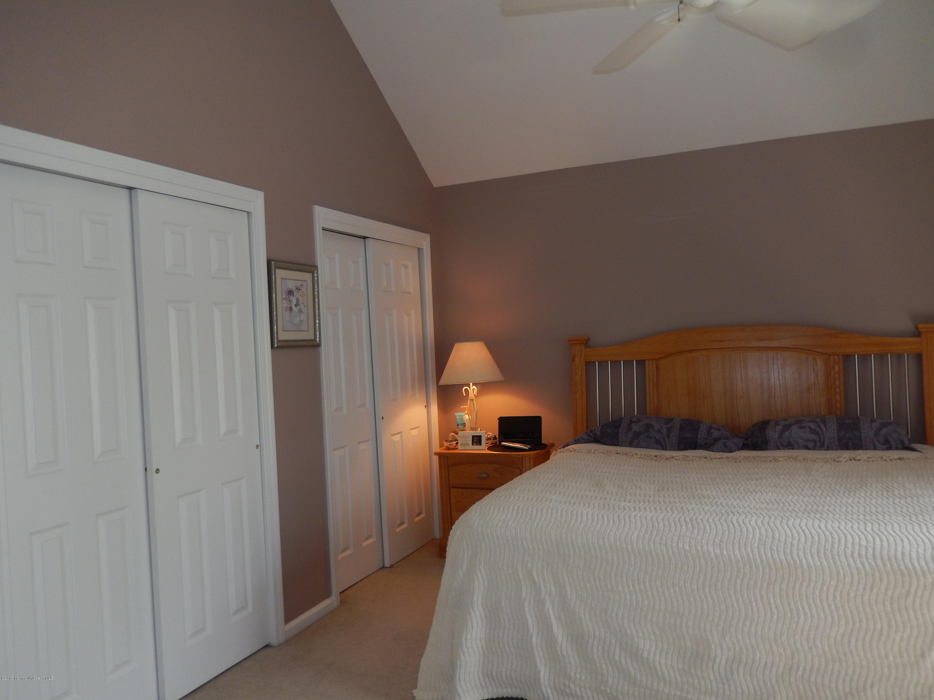 100 Bowsprit Road Manahawkin, NJ 08050 - Photo 15 of 21 a bed room with a bed and a night stand
