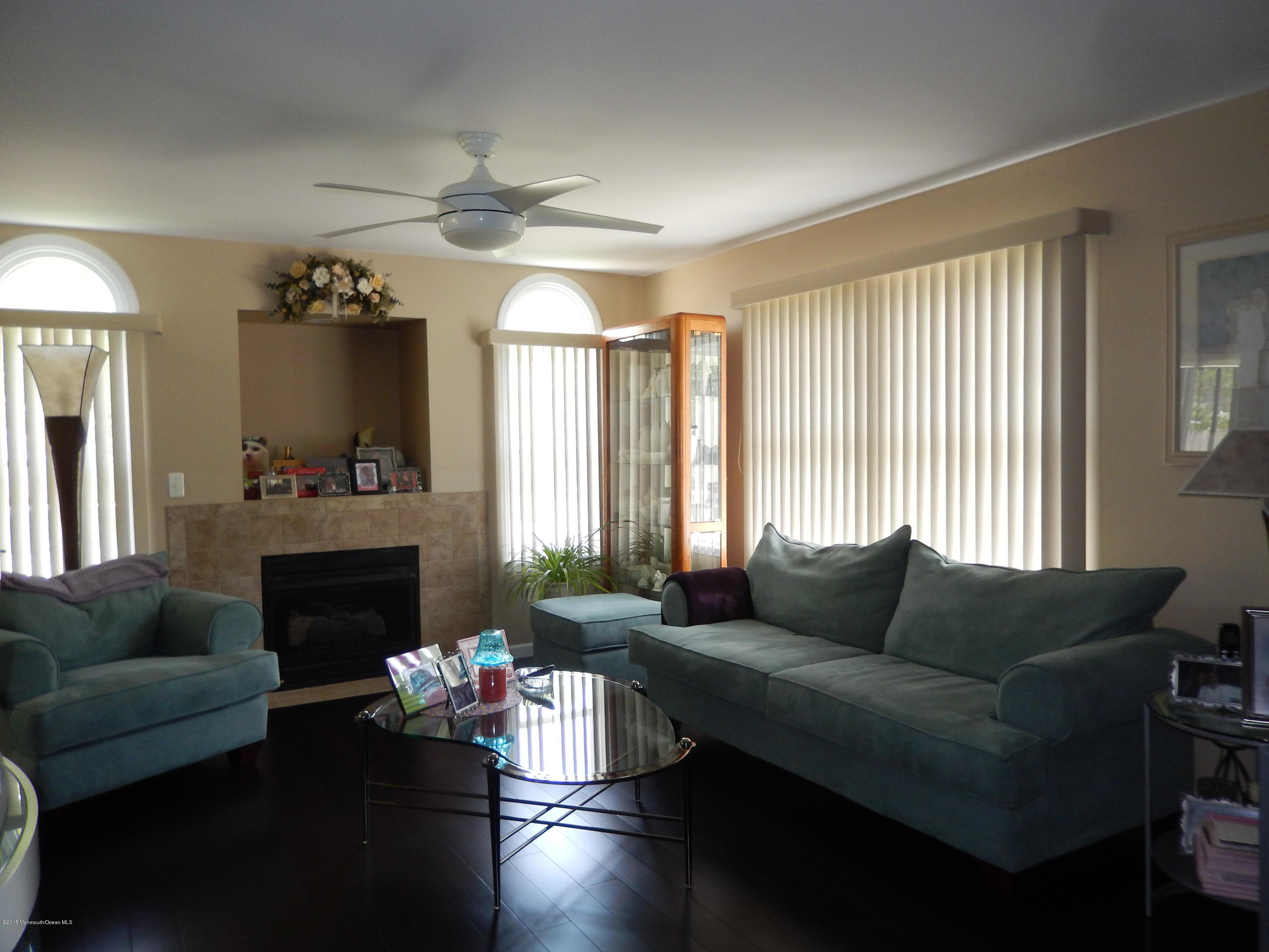 100 Bowsprit Road Manahawkin, NJ 08050 - Photo 3 of 21 a living room with furniture fireplace and a large window