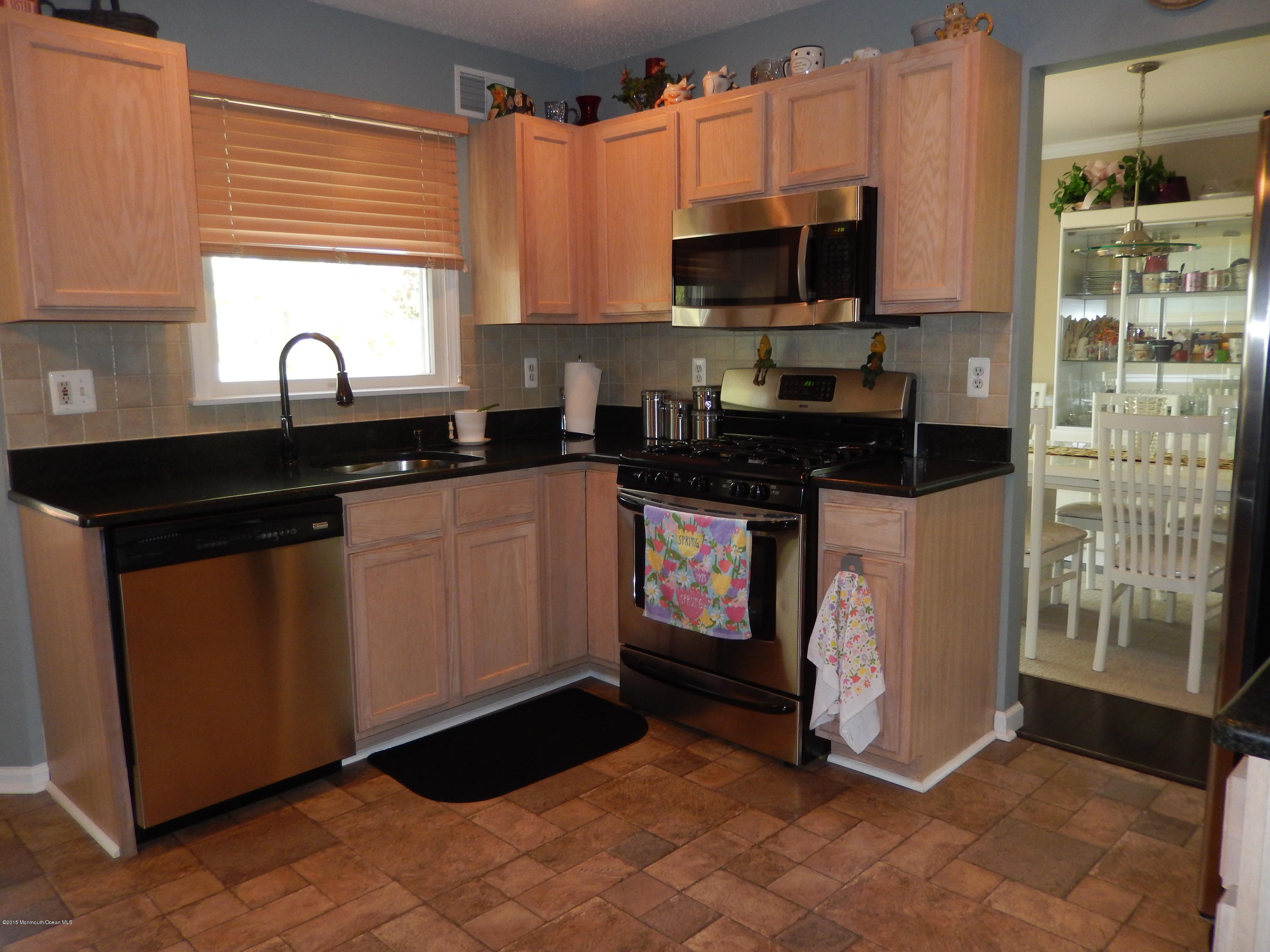 100 Bowsprit Road Manahawkin, NJ 08050 - Photo 5 of 21 a kitchen with stainless steel appliances granite countertop a stove a sink and a microwave