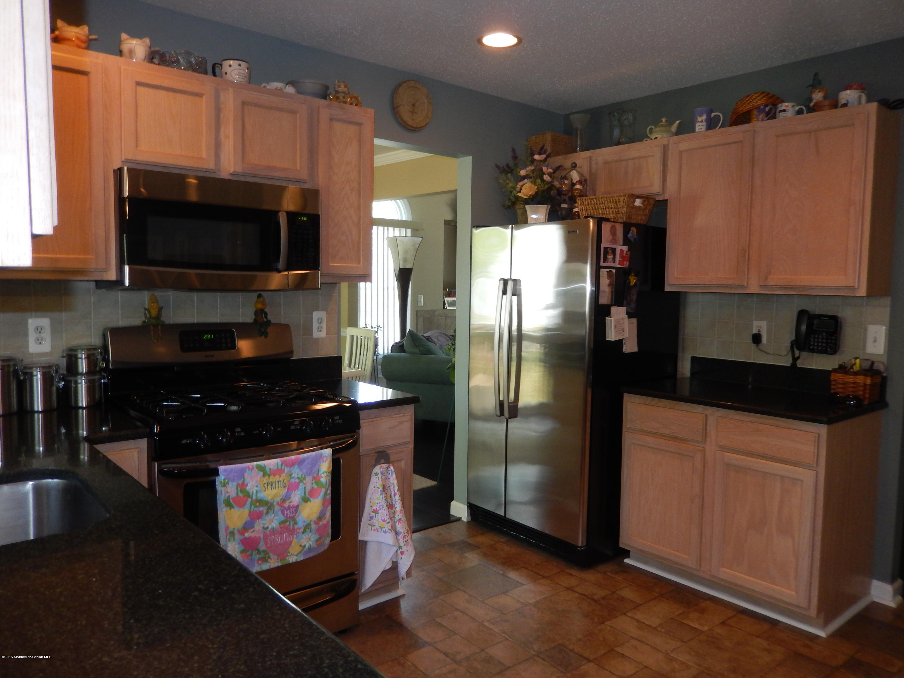 100 Bowsprit Road Manahawkin, NJ 08050 - Photo 6 of 21 a kitchen with stainless steel appliances a refrigerator a stove a microwave and cabinets