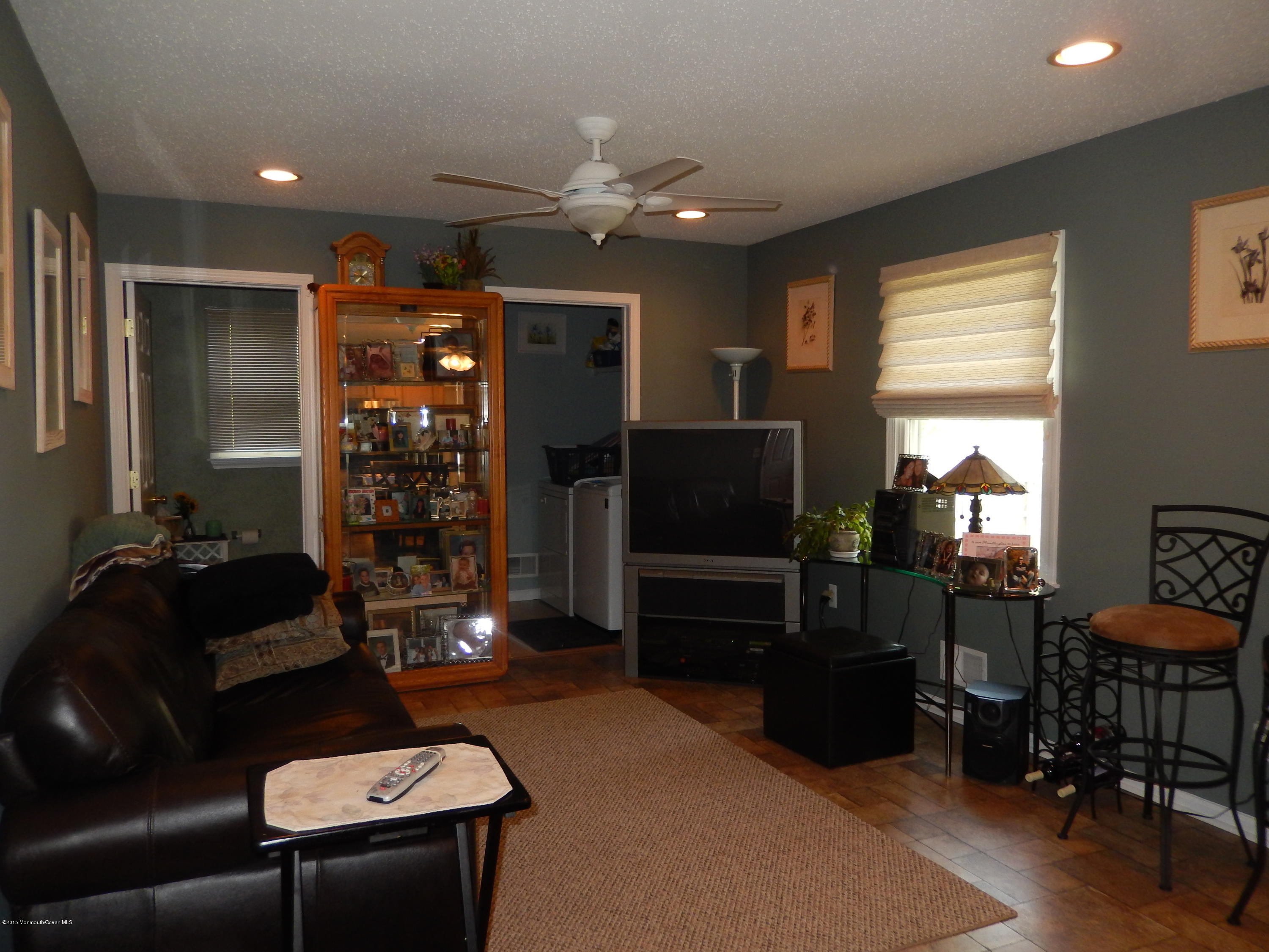 100 Bowsprit Road Manahawkin, NJ 08050 - Photo 8 of 21 a living room with furniture a lamp and a window