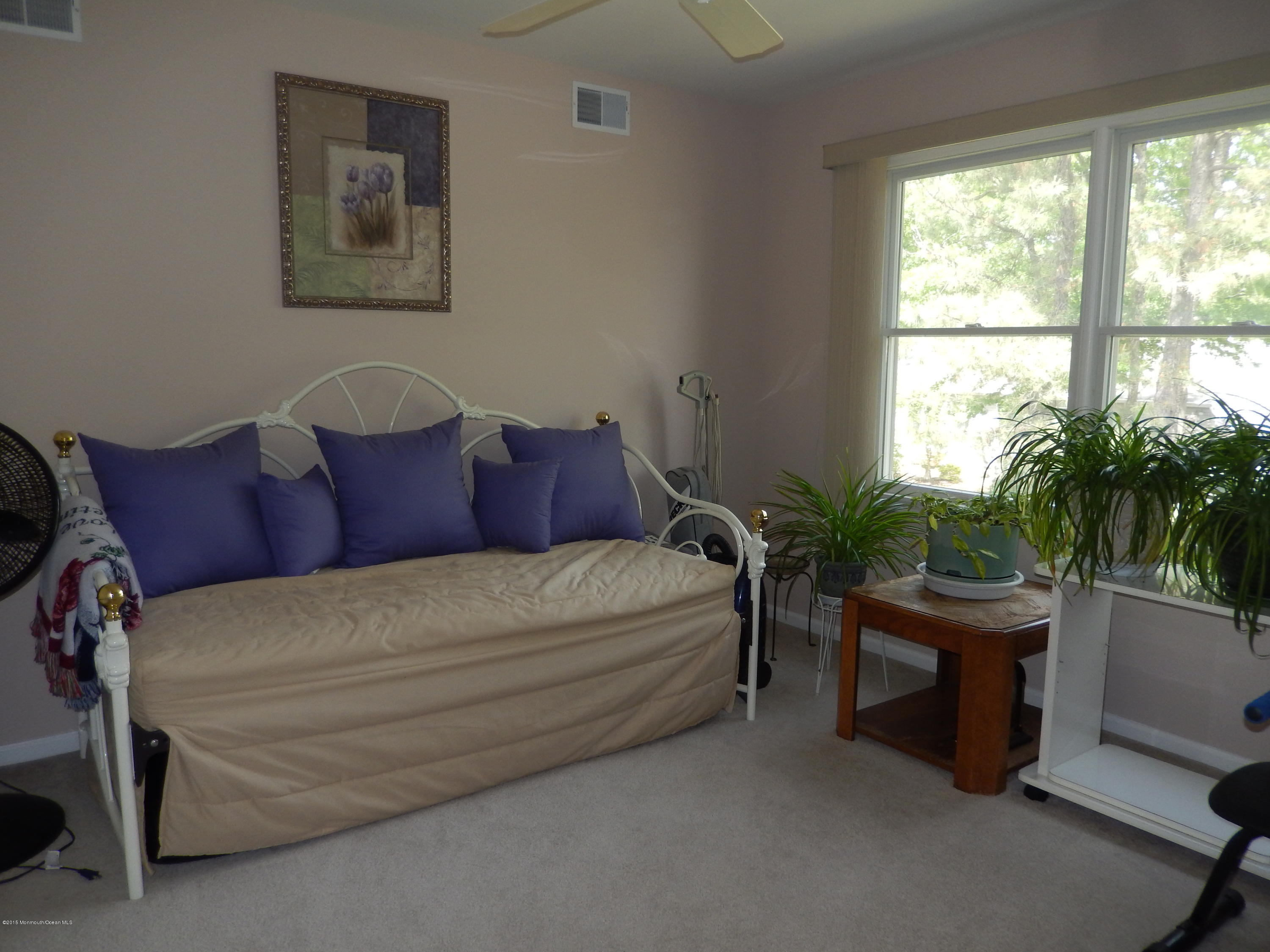 100 Bowsprit Road Manahawkin, NJ 08050 - Photo 10 of 21 a bedroom with a bed and a potted plant
