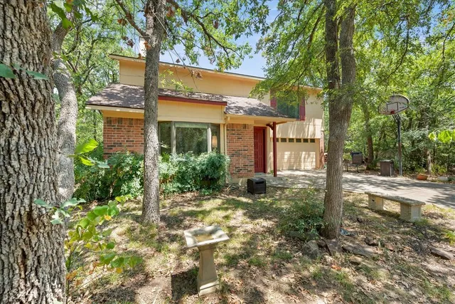 a front view of a house with a yard garage and outdoor seating