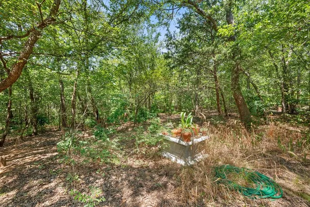 a kitchen with a sink a stove a refrigerator and a window