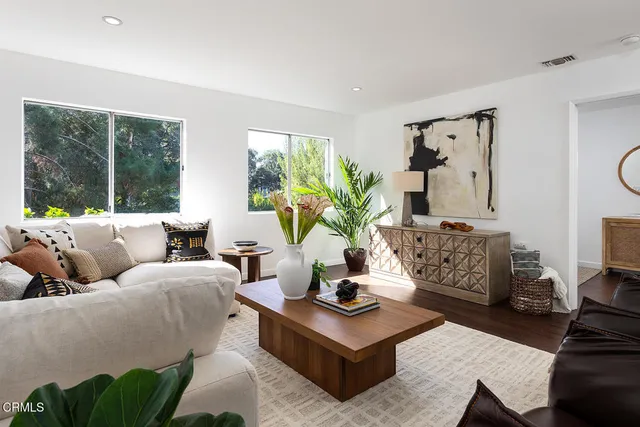 a living room with furniture and a mirror