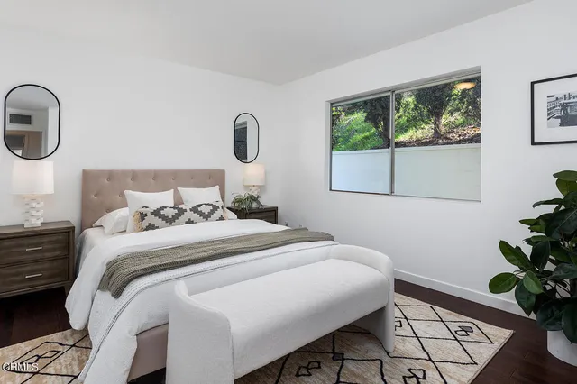 a bedroom with a bed and a window