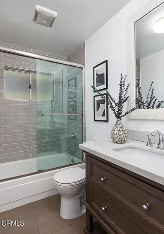 a bathroom with a sink a vanity and shower