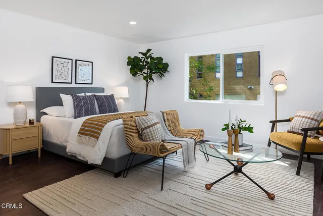 a kitchen with a sink a large window and a potted plant