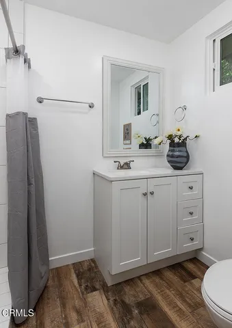 a view of a workspace with furniture and wooden floor