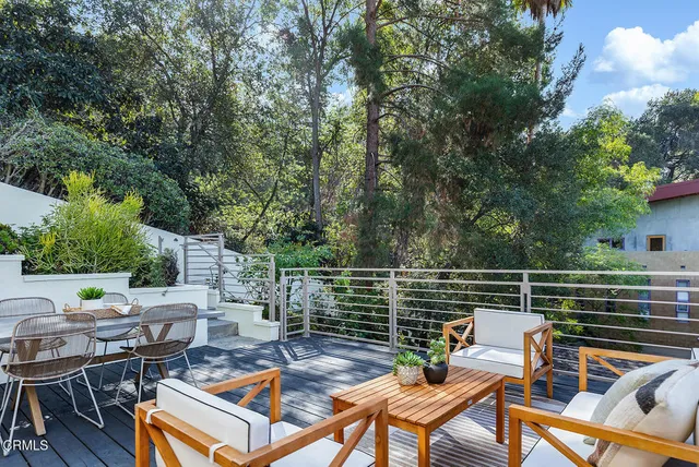 a backyard of a house with table and chairs