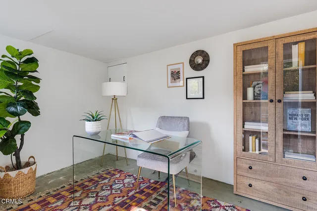 a balcony with furniture and a potted plant