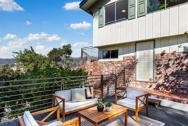 a view of balcony with two chairs and a table