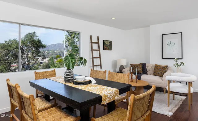 a view of a dining room with a table and chairs