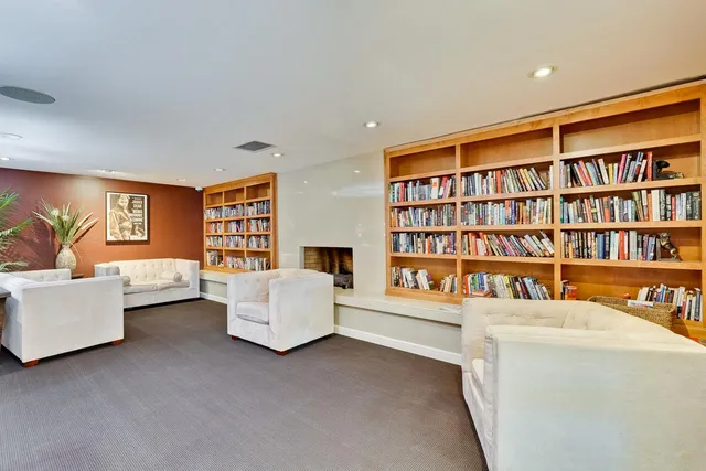a living room with furniture and a book shelf