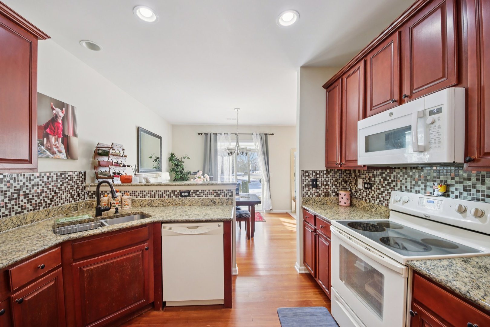 424 Acushnet Street Elgin, IL 60124 - Photo 7 of 21 a kitchen with stainless steel appliances granite countertop a stove and a sink