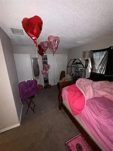 a bedroom with a bed and dresser