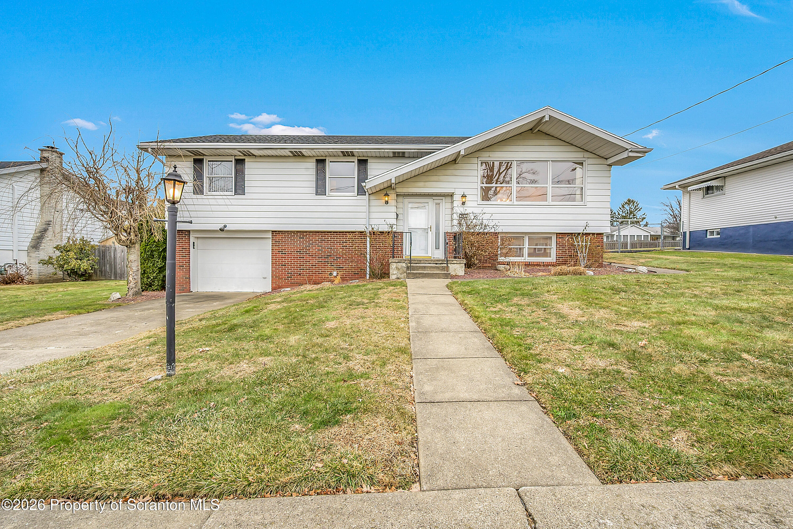 803 June Lane Moosic, PA 18507 - Photo 1 of 36 a front view of a house with garden