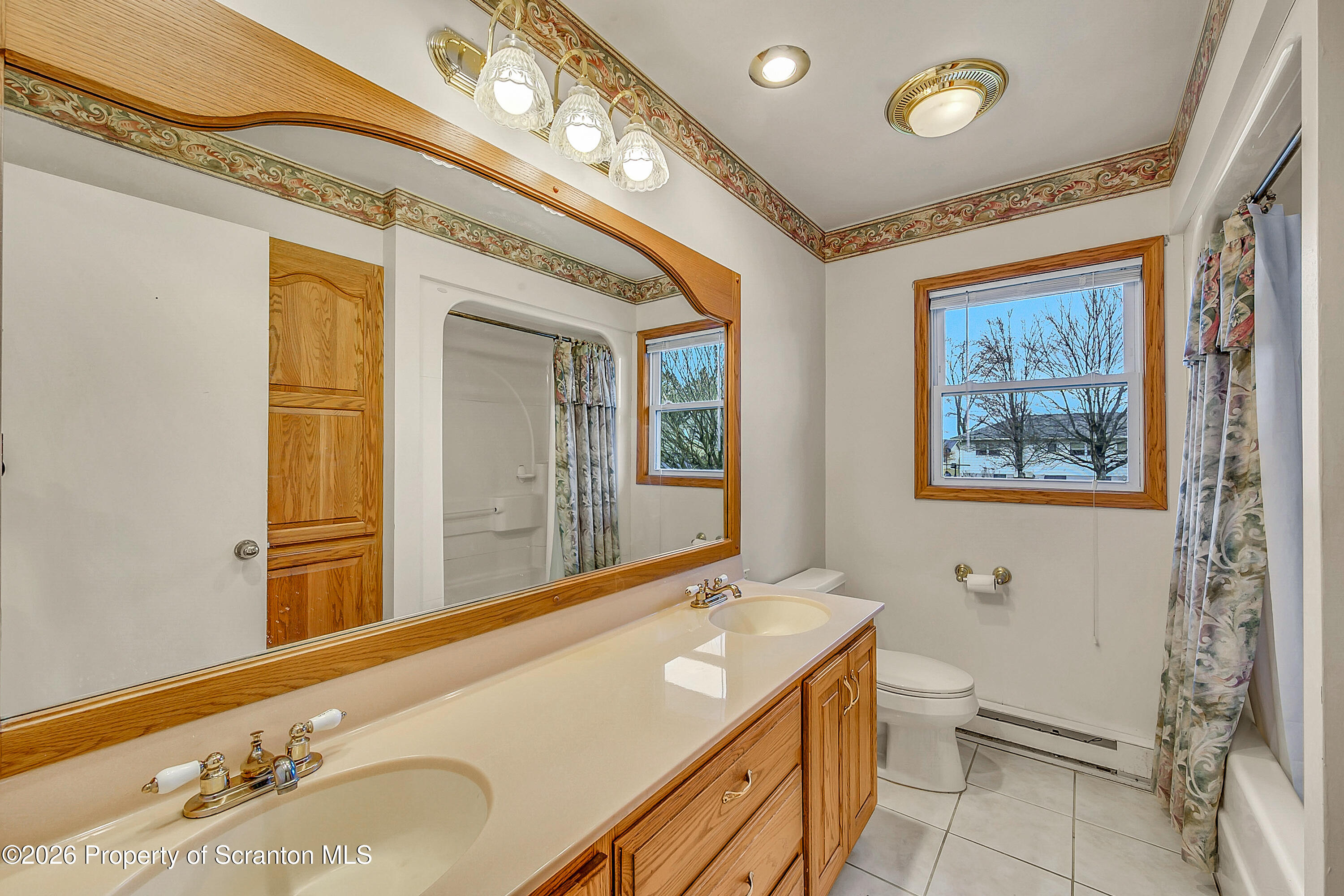 803 June Lane Moosic, PA 18507 - Photo 18 of 36 a bathroom with a granite countertop sink mirror vanity and toilet