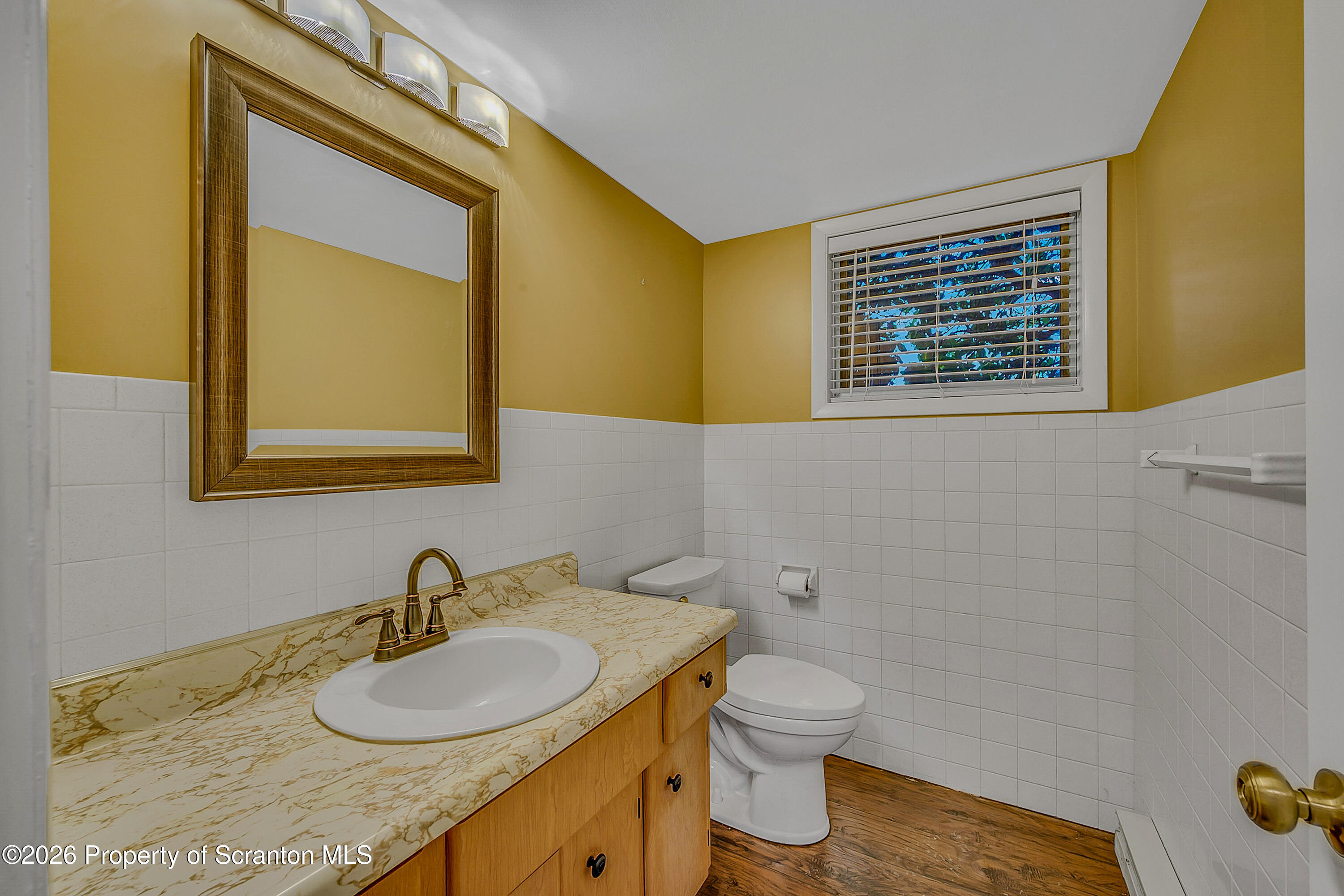 803 June Lane Moosic, PA 18507 - Photo 32 of 36 a bathroom with a granite countertop toilet sink and mirror