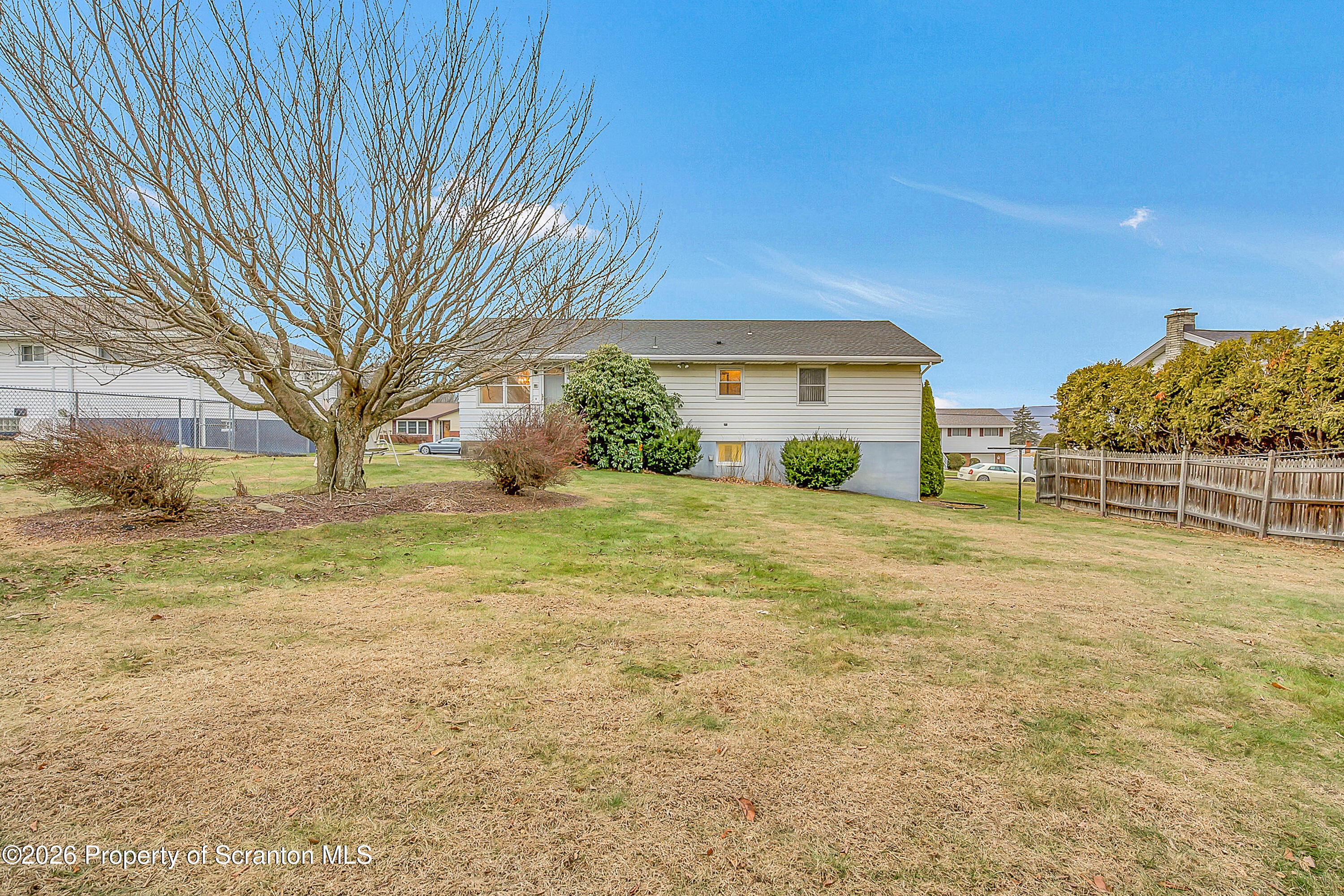 803 June Lane Moosic, PA 18507 - Photo 5 of 36 a view of a house with backyard and tree