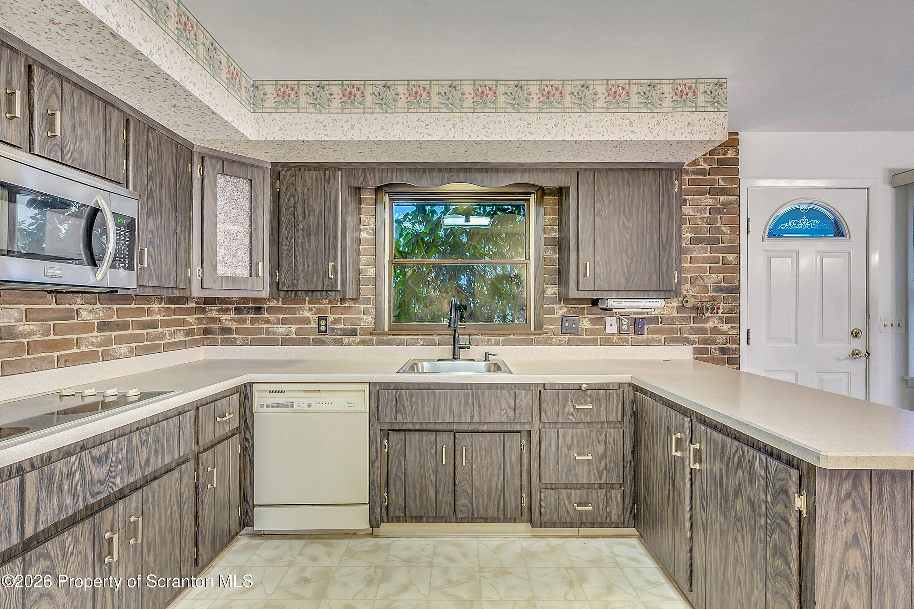 803 June Lane Moosic, PA 18507 - Photo 9 of 36 a kitchen with a sink stove and cabinets