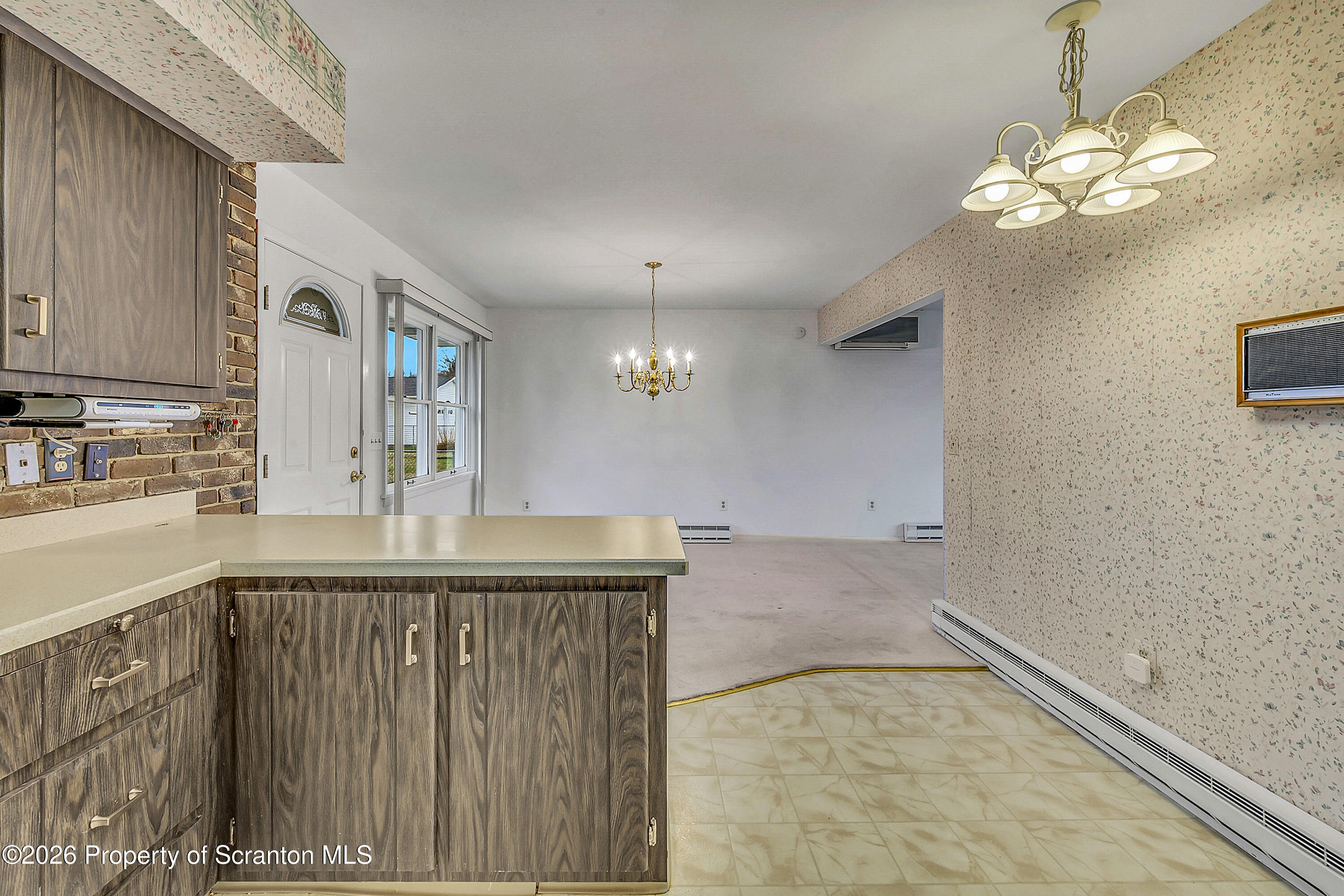 803 June Lane Moosic, PA 18507 - Photo 10 of 36 a view of a kitchen with a sink and chandelier
