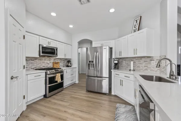 a kitchen with a refrigerator stove and sink
