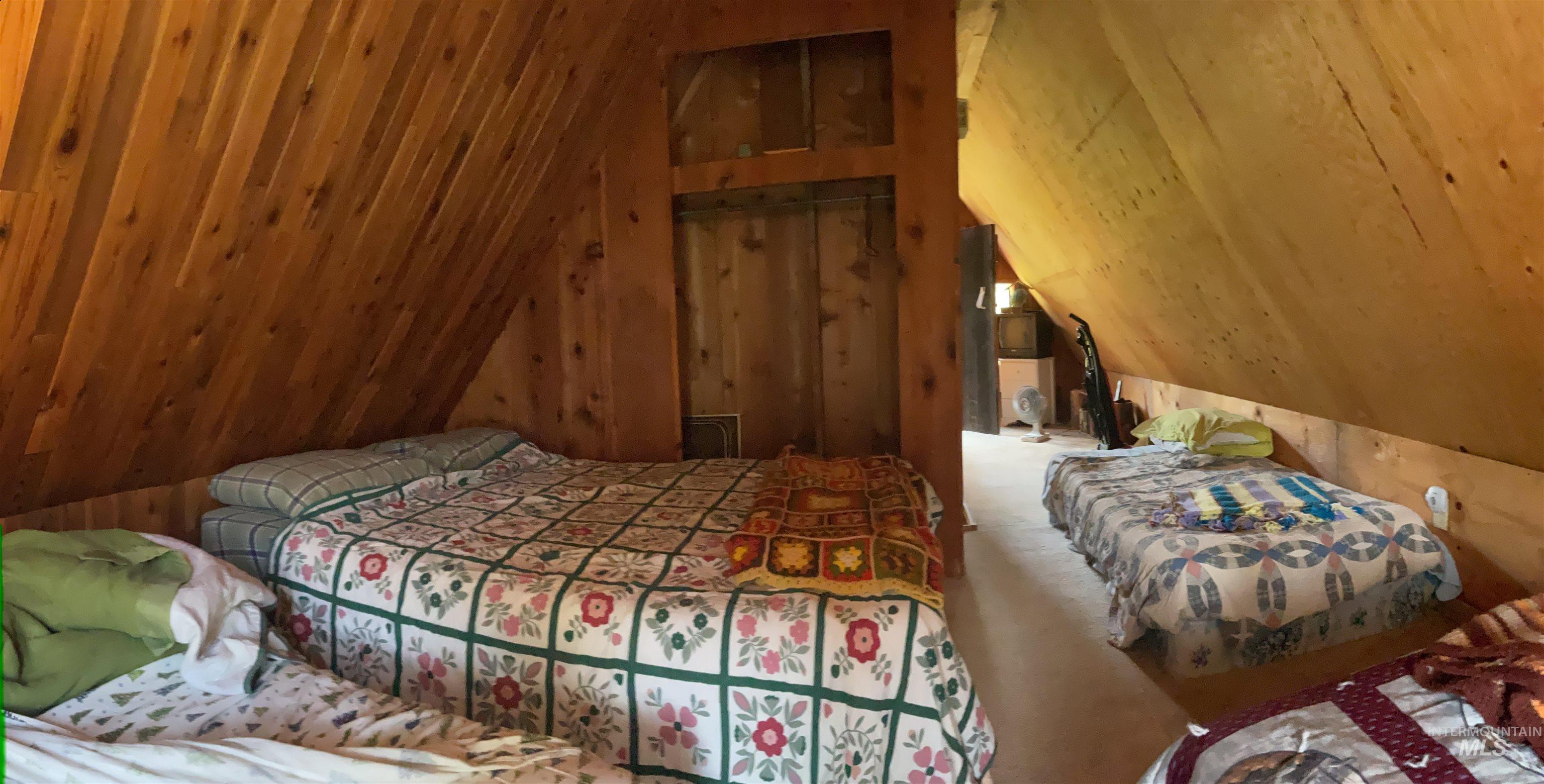 2871 Orogrande-Dixie Road Elk City, ID 83525 - Photo 27 of 40 Attic space featuring wood-paneled walls and sloped ceilings