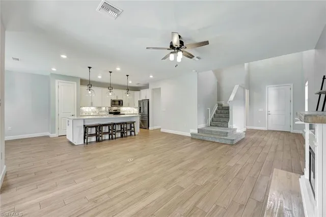 a view of a kitchen with kitchen island a stove and a wooden floor
