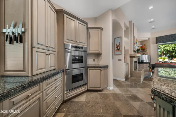 a kitchen with stainless steel appliances a refrigerator sink and microwave
