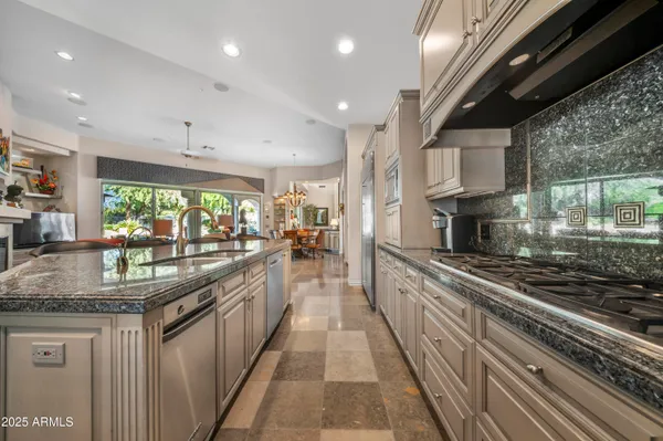 a large kitchen with stainless steel appliances granite countertop lots of counter top space