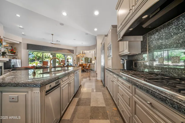 a large kitchen with stainless steel appliances granite countertop lots of counter top space