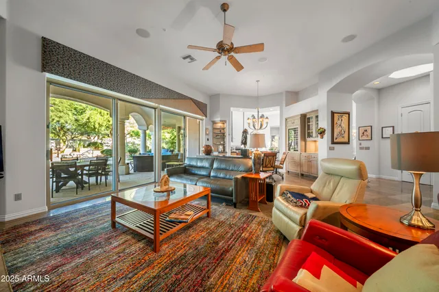 a living room with furniture a rug and a large window
