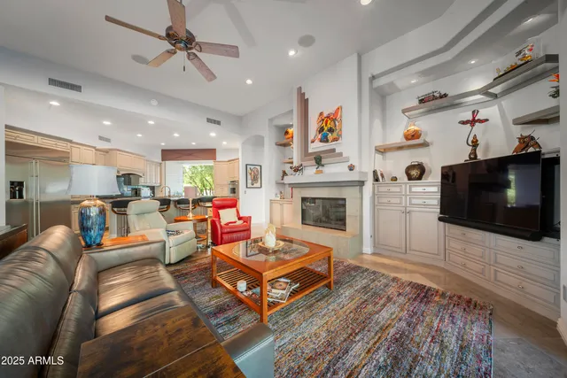 a living room with furniture fireplace and flat screen tv