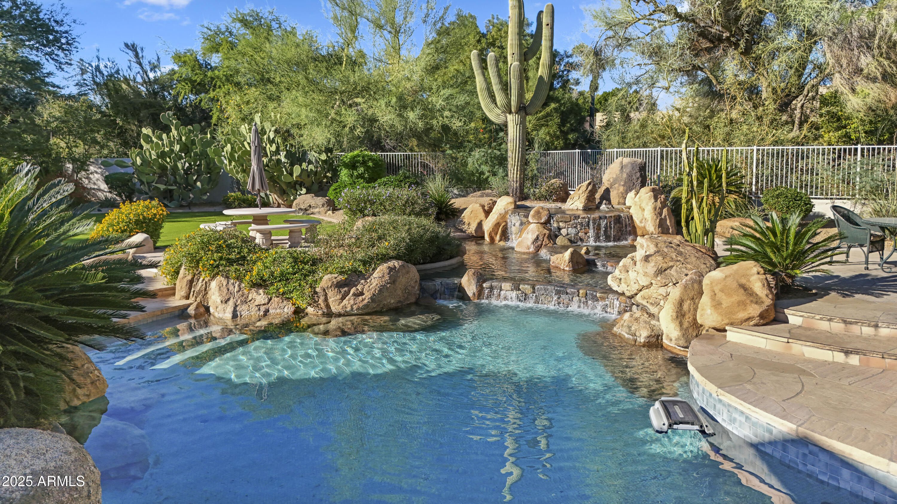 8350 East Via Del Sol Drive Scottsdale, AZ 85255 - Photo 2 of 42 a view of a swimming pool with a patio and garden