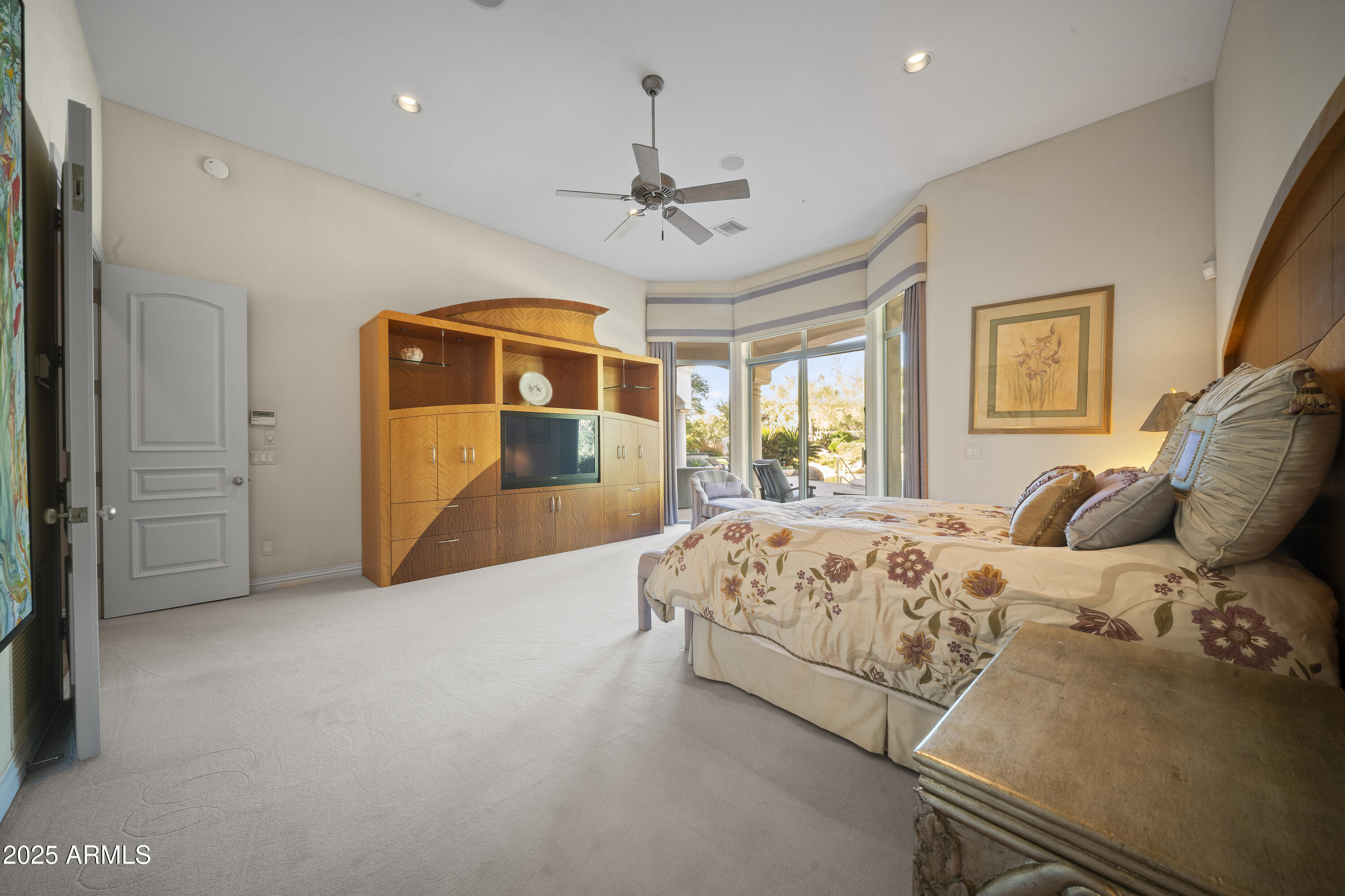 8350 East Via Del Sol Drive Scottsdale, AZ 85255 - Photo 22 of 42 a spacious bedroom with a bed and a chandelier