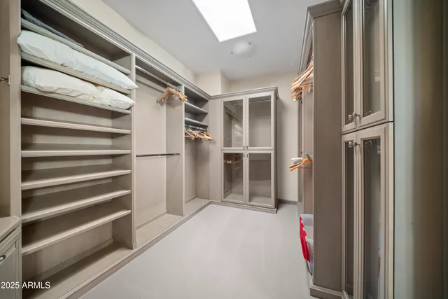 a view of walk in closet with empty racks