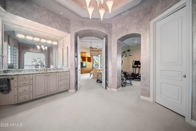 a large room with a mirror and a view of living room