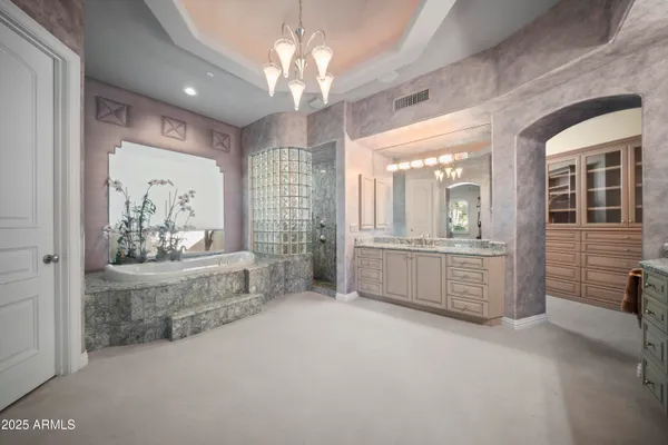 a large spacious bathroom with a large tub shower and sink