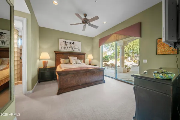 a bedroom with a bed and a tv