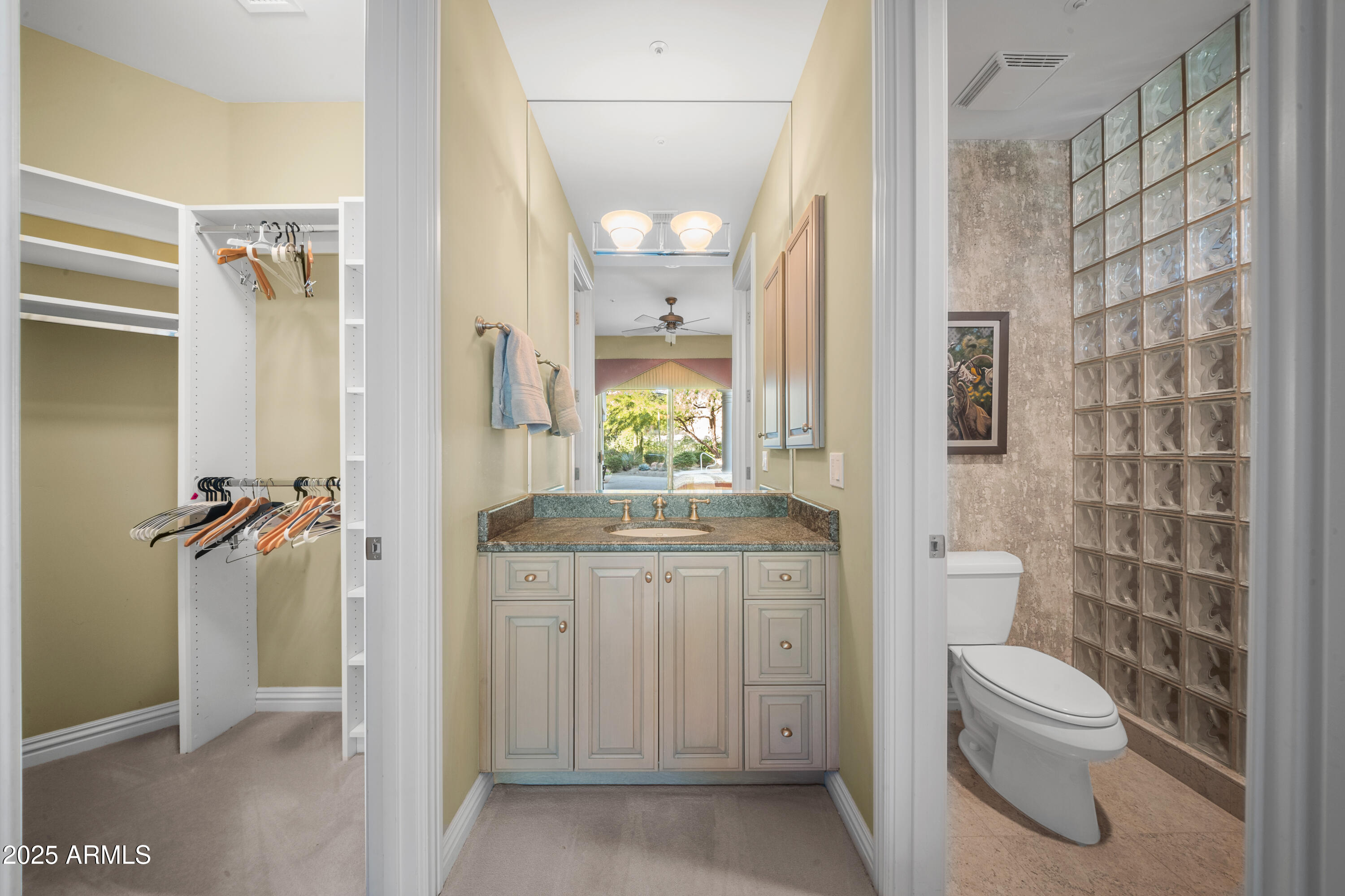 8350 East Via Del Sol Drive Scottsdale, AZ 85255 - Photo 28 of 42 a bathroom with a granite countertop toilet a sink and a mirror