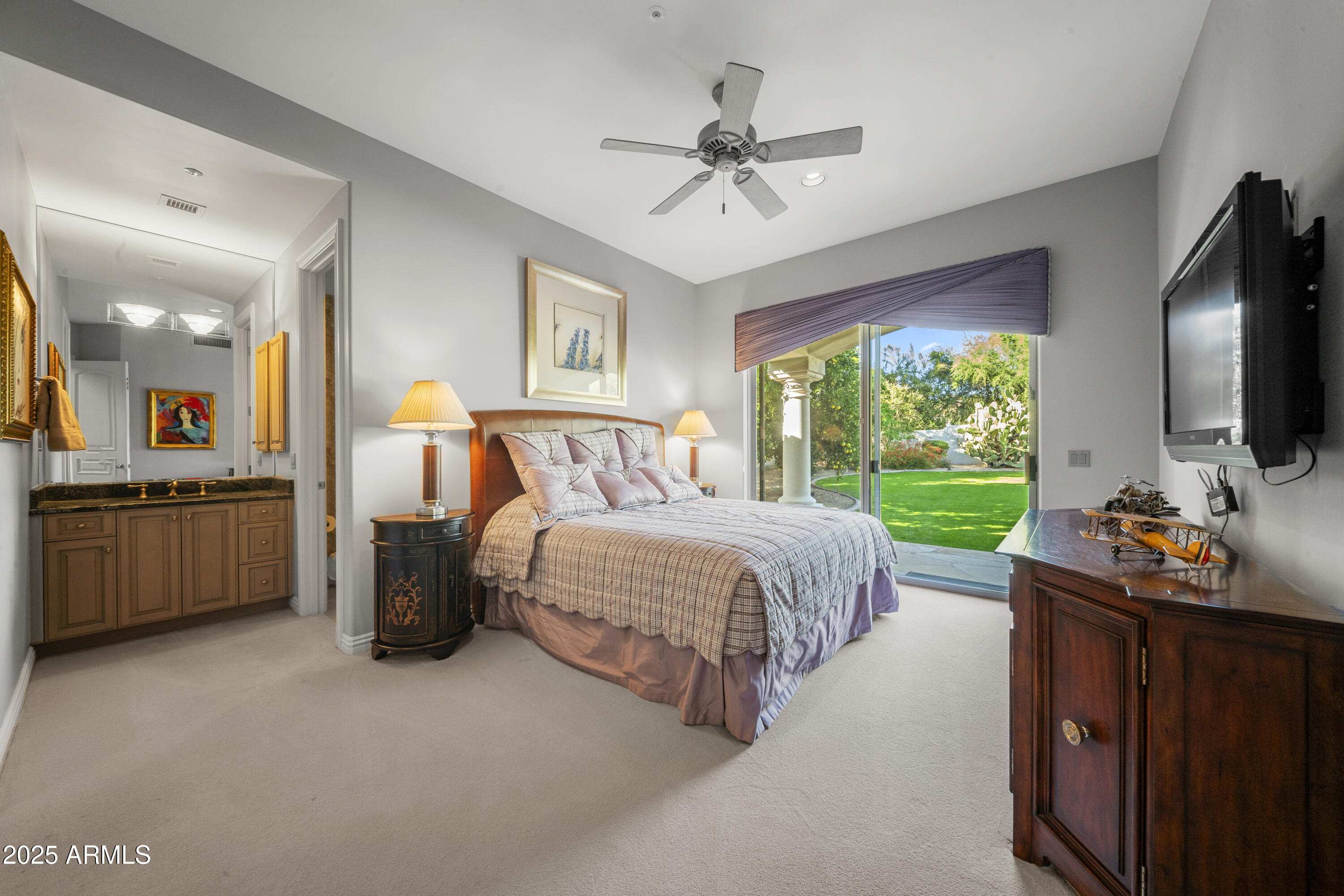 8350 East Via Del Sol Drive Scottsdale, AZ 85255 - Photo 31 of 42 a bedroom with a bed and a flat tv screen on dresser