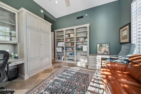 a living room with furniture a rug and a window