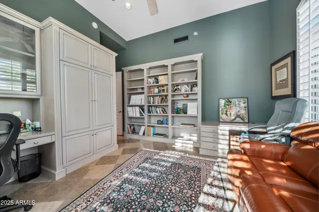 a living room with furniture a rug and a window
