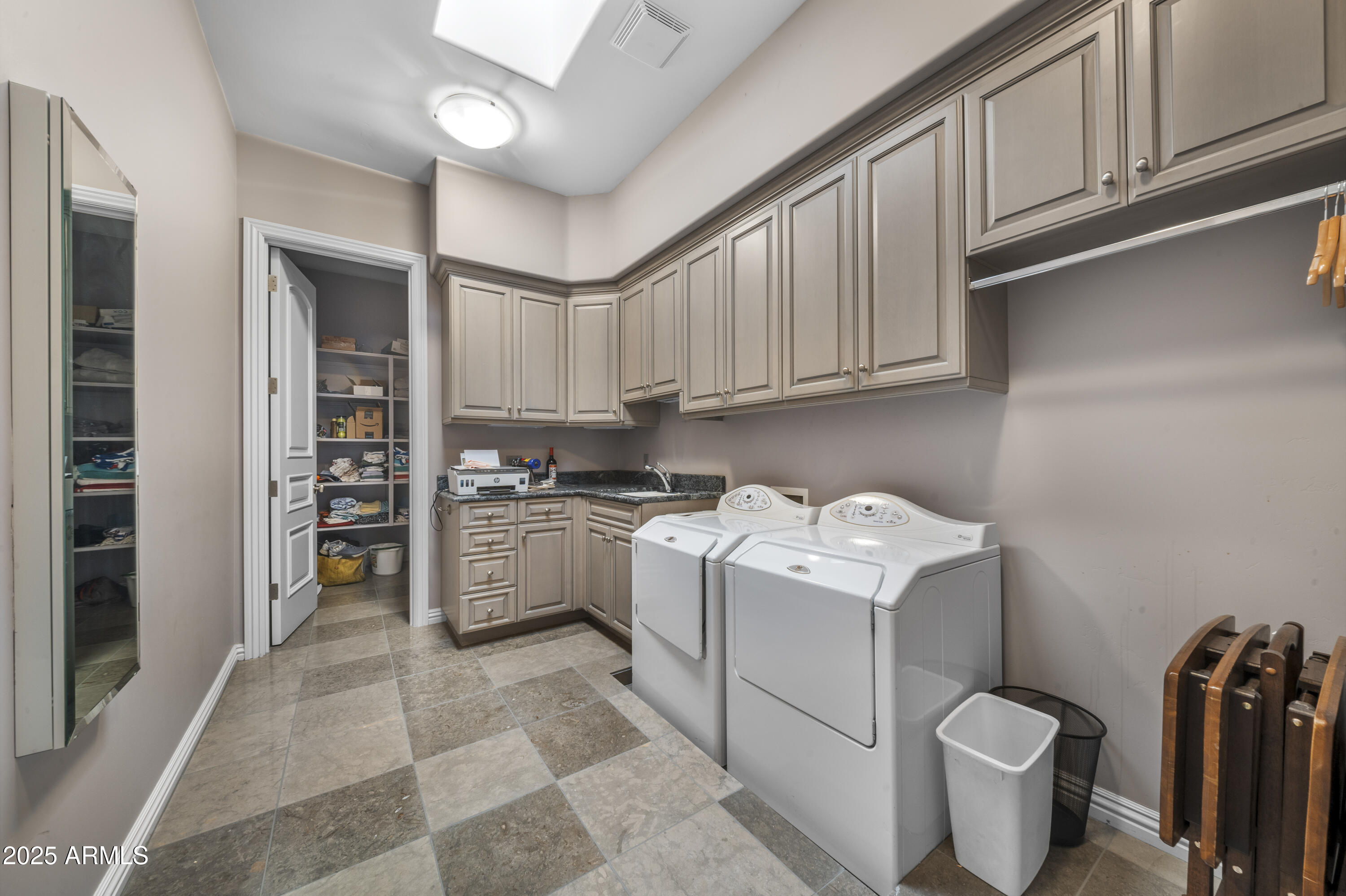8350 East Via Del Sol Drive Scottsdale, AZ 85255 - Photo 36 of 42 a kitchen with a stove top oven and cabinets